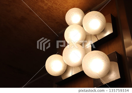Light bulb shining on the ceiling Light bulb shining on the ceiling 135759334