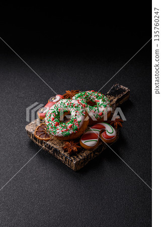 Christmas donuts or doughnuts, holiday winter sweets with sprinkles. Christmas donuts Christmas donuts or doughnuts, holiday winter sweets with sprinkles. Christmas donuts 135760247
