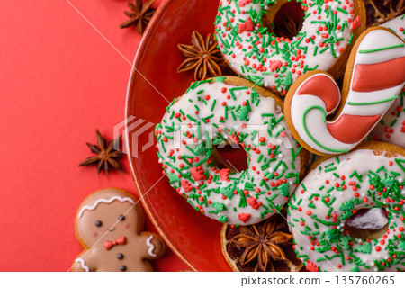 Christmas donuts or doughnuts, holiday winter sweets with sprinkles. Christmas donuts Christmas donuts or doughnuts, holiday winter sweets with sprinkles. Christmas donuts 135760265