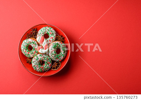 Christmas donuts or doughnuts, holiday winter sweets with sprinkles. Christmas donuts Christmas donuts or doughnuts, holiday winter sweets with sprinkles. Christmas donuts 135760273
