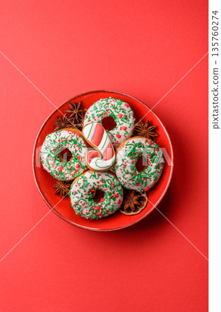 Christmas donuts or doughnuts, holiday winter sweets with sprinkles. Christmas donuts Christmas donuts or doughnuts, holiday winter sweets with sprinkles. Christmas donuts 135760274