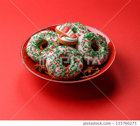 Christmas donuts or doughnuts, holiday winter sweets with sprinkles. Christmas donuts Christmas donuts or doughnuts, holiday winter sweets with sprinkles. Christmas donuts 135760275