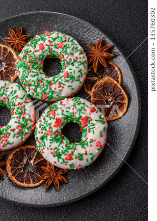 Christmas donuts or doughnuts, holiday winter sweets with sprinkles. Christmas donuts Christmas donuts or doughnuts, holiday winter sweets with sprinkles. Christmas donuts 135760302
