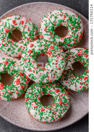 Christmas donuts or doughnuts, holiday winter sweets with sprinkles. Christmas donuts 135760314