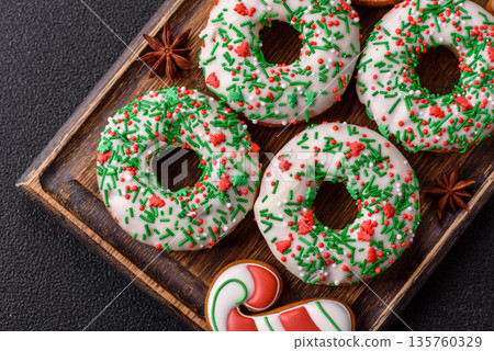 Christmas donuts or doughnuts, holiday winter sweets with sprinkles. Christmas donuts Christmas donuts or doughnuts, holiday winter sweets with sprinkles. Christmas donuts 135760329