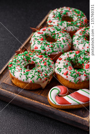 Christmas donuts or doughnuts, holiday winter sweets with sprinkles. Christmas donuts Christmas donuts or doughnuts, holiday winter sweets with sprinkles. Christmas donuts 135760331