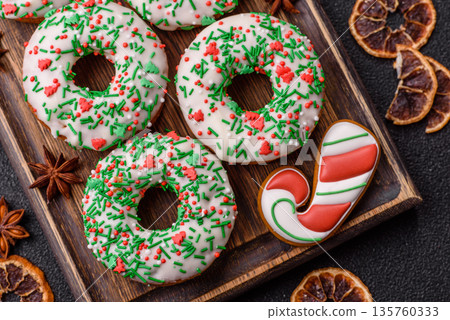 Christmas donuts or doughnuts, holiday winter sweets with sprinkles. Christmas donuts Christmas donuts or doughnuts, holiday winter sweets with sprinkles. Christmas donuts 135760333