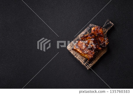 Grilled or bbq pork ribs with sauce, a food prepared for dinner. Grilled ribs 135760383