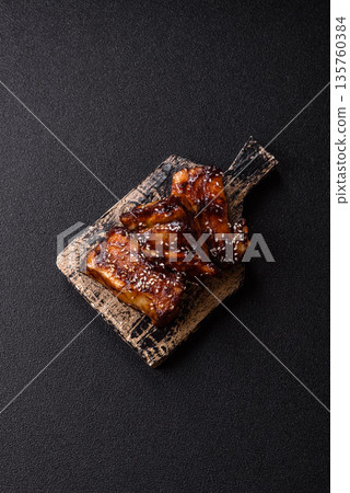 Grilled or bbq pork ribs with sauce, a food prepared for dinner. Grilled ribs Grilled or bbq pork ribs with sauce, a food prepared for dinner. Grilled ribs 135760384