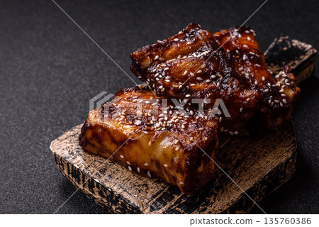 Grilled or bbq pork ribs with sauce, a food prepared for dinner. Grilled ribs Grilled or bbq pork ribs with sauce, a food prepared for dinner. Grilled ribs 135760386
