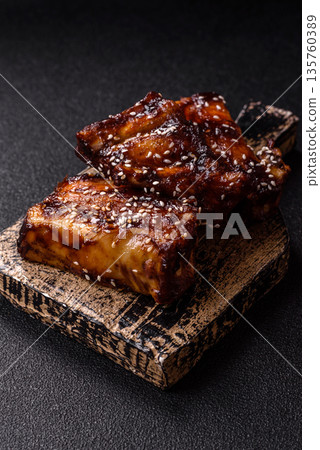 Grilled or bbq pork ribs with sauce, a food prepared for dinner. Grilled ribs 135760389