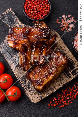 Grilled or bbq pork ribs with sauce, a food prepared for dinner. Grilled ribs Grilled or bbq pork ribs with sauce, a food prepared for dinner. Grilled ribs 135760392