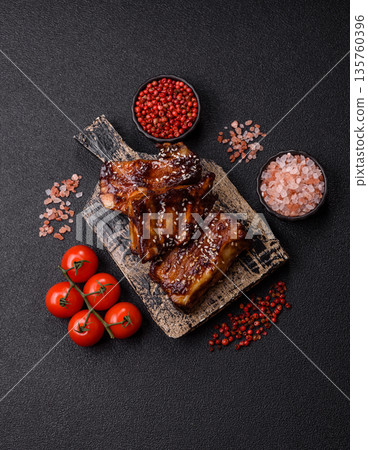 Grilled or bbq pork ribs with sauce, a food prepared for dinner. Grilled ribs 135760396