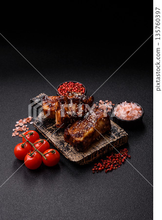 Grilled or bbq pork ribs with sauce, a food prepared for dinner. Grilled ribs 135760397