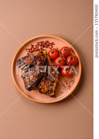 Grilled or bbq pork ribs with sauce, a food prepared for dinner. Grilled ribs 135760400