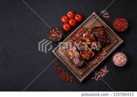 Grilled or bbq pork ribs with sauce, a food prepared for dinner. Grilled ribs Grilled or bbq pork ribs with sauce, a food prepared for dinner. Grilled ribs 135760415