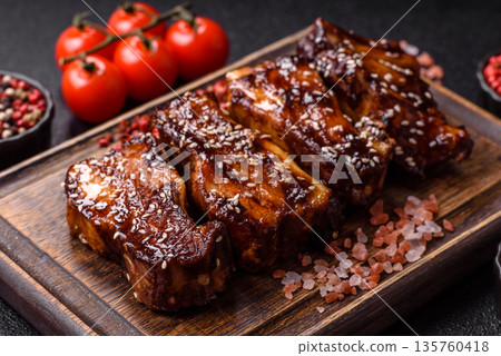 Grilled or bbq pork ribs with sauce, a food prepared for dinner. Grilled ribs 135760418