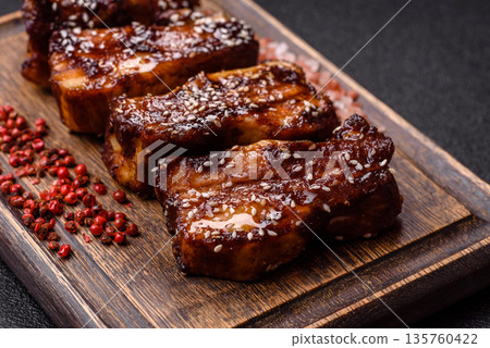 Grilled or bbq pork ribs with sauce, a food prepared for dinner. Grilled ribs Grilled or bbq pork ribs with sauce, a food prepared for dinner. Grilled ribs 135760422