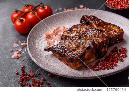 Grilled or bbq pork ribs with sauce, a food prepared for dinner. Grilled ribs 135760434