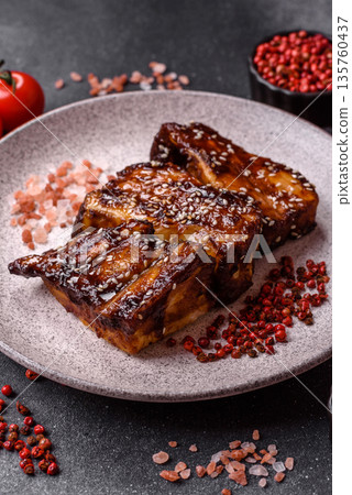 Grilled or bbq pork ribs with sauce, a food prepared for dinner. Grilled ribs Grilled or bbq pork ribs with sauce, a food prepared for dinner. Grilled ribs 135760437