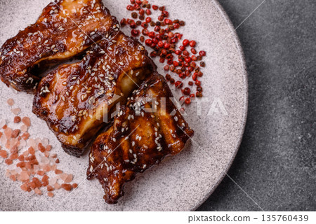 Grilled or bbq pork ribs with sauce, a food prepared for dinner. Grilled ribs 135760439