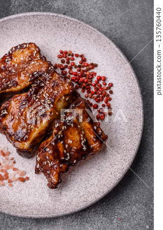 Grilled or bbq pork ribs with sauce, a food prepared for dinner. Grilled ribs 135760440