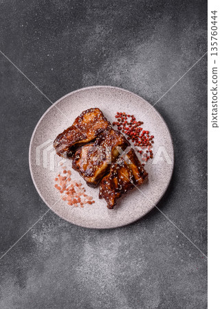 Grilled or bbq pork ribs with sauce, a food prepared for dinner. Grilled ribs Grilled or bbq pork ribs with sauce, a food prepared for dinner. Grilled ribs 135760444