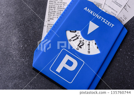 A parking disc, permit, or ticket for measuring time and paying municipal services. A parking disc 135760744