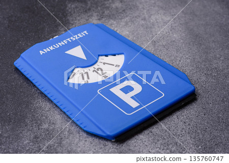 A parking disc, permit, or ticket for measuring time and paying municipal services. A parking disc A parking disc, permit, or ticket for measuring time and paying municipal services. A parking disc 135760747