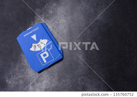 A parking disc, permit, or ticket for measuring time and paying municipal services. A parking disc 135760752
