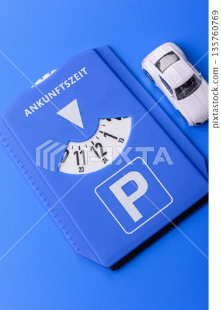 A parking disc, permit, or ticket for measuring time and paying municipal services. A parking disc A parking disc, permit, or ticket for measuring time and paying municipal services. A parking disc 135760769