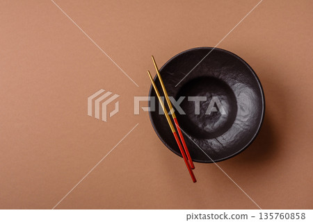 An empty round ceramic plate on a table, kitchenware. An empty plate An empty round ceramic plate on a table, kitchenware. An empty plate 135760858