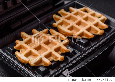 Belgian waffles, a healthy sweet breakfast dessert, food background. Belgian waffles Belgian waffles, a healthy sweet breakfast dessert, food background. Belgian waffles 135761199