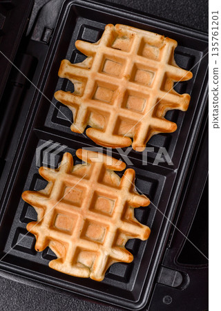 Belgian waffles, a healthy sweet breakfast dessert, food background. Belgian waffles Belgian waffles, a healthy sweet breakfast dessert, food background. Belgian waffles 135761201