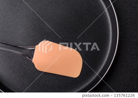 An empty black metal frying pan, kitchen utensils for cooking. An empty frying pan An empty black metal frying pan, kitchen utensils for cooking. An empty frying pan 135761226