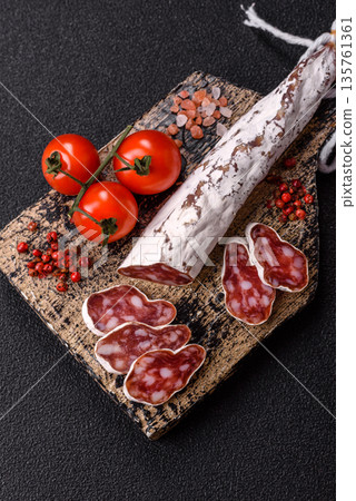 Dry Spanish salami sausage fuet as a snack for the dinner table. Fuet sausage Dry Spanish salami sausage fuet as a snack for the dinner table. Fuet sausage 135761361