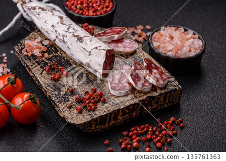 Dry Spanish salami sausage fuet as a snack for the dinner table. Fuet sausage Dry Spanish salami sausage fuet as a snack for the dinner table. Fuet sausage 135761363