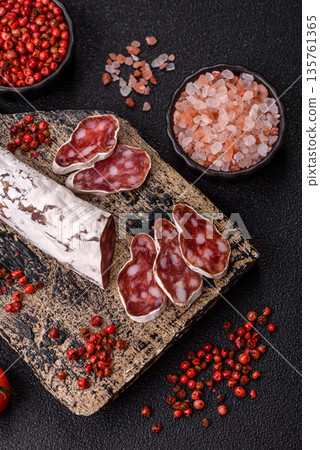 Dry Spanish salami sausage fuet as a snack for the dinner table. Fuet sausage Dry Spanish salami sausage fuet as a snack for the dinner table. Fuet sausage 135761365