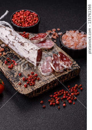 Dry Spanish salami sausage fuet as a snack for the dinner table. Fuet sausage Dry Spanish salami sausage fuet as a snack for the dinner table. Fuet sausage 135761366