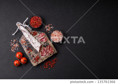 Dry Spanish salami sausage fuet as a snack for the dinner table. Fuet sausage Dry Spanish salami sausage fuet as a snack for the dinner table. Fuet sausage 135761368