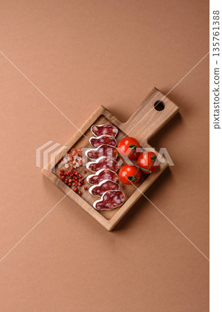 Dry Spanish salami sausage fuet as a snack for the dinner table. Fuet sausage 135761388