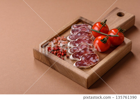 Dry Spanish salami sausage fuet as a snack for the dinner table. Fuet sausage Dry Spanish salami sausage fuet as a snack for the dinner table. Fuet sausage 135761390