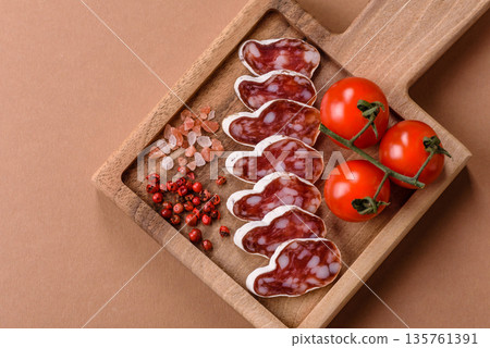 Dry Spanish salami sausage fuet as a snack for the dinner table. Fuet sausage 135761391