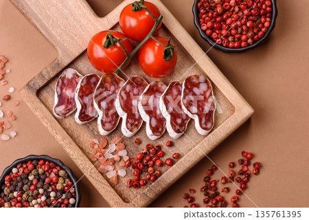 Dry Spanish salami sausage fuet as a snack for the dinner table. Fuet sausage Dry Spanish salami sausage fuet as a snack for the dinner table. Fuet sausage 135761395