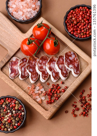 Dry Spanish salami sausage fuet as a snack for the dinner table. Fuet sausage Dry Spanish salami sausage fuet as a snack for the dinner table. Fuet sausage 135761396