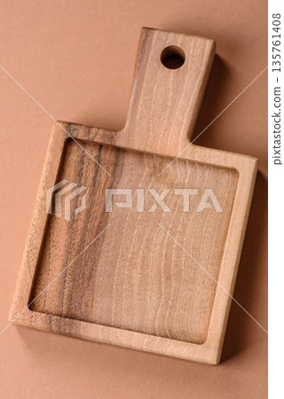 Wood, a wooden empty cutting board on a dark kitchen table. Wooden cutting board Wood, a wooden empty cutting board on a dark kitchen table. Wooden cutting board 135761408