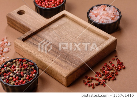 Wood, a wooden empty cutting board on a dark kitchen table. Wooden cutting board Wood, a wooden empty cutting board on a dark kitchen table. Wooden cutting board 135761410