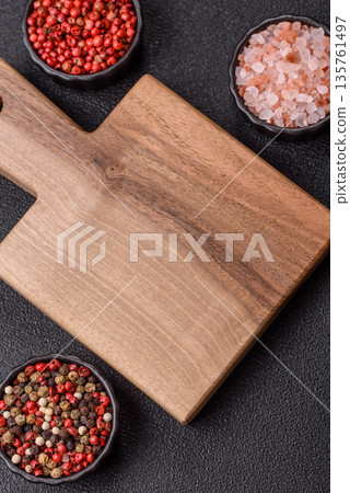 Wood, a wooden empty cutting board on a dark kitchen table. Wooden cutting board 135761497