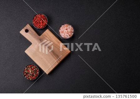 Wood, a wooden empty cutting board on a dark kitchen table. Wooden cutting board Wood, a wooden empty cutting board on a dark kitchen table. Wooden cutting board 135761500