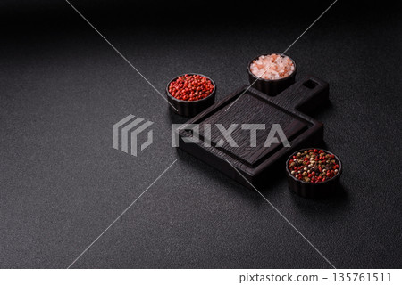 Wood, a wooden empty cutting board on a dark kitchen table. Wooden cutting board Wood, a wooden empty cutting board on a dark kitchen table. Wooden cutting board 135761511